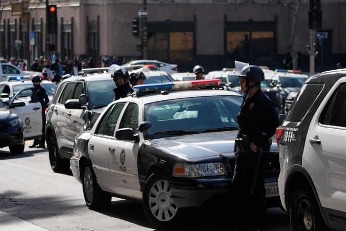 Los Angeles Police Riot police officer declare an unlawful assembly after a fist fight among high students broke at a rally to stop President Trump's mass deportations and demand immigration reform at Grand Park in downtown Los Angeles on Friday, Feb. 7, 2025. (AP Photo/Damian Dovarganes)
