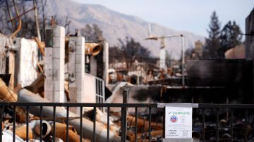 A notice from the EPA declaring that all hazardous materials have been removed form a property is pictured on Lake Avenue, Monday, Feb. 17, 2025, in in Altadena, Calif. (AP Photo/Chris Pizzello)