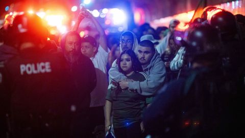 Police detain demonstrators as they are escorted out during an immigration rights protest Monday, Feb. 3, 2025, in Los Angeles. (AP Photo/Ethan Swope)