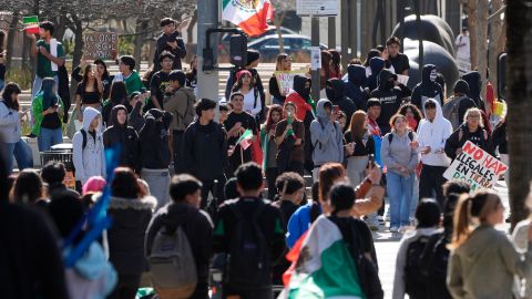 High school students disperse after police declared an unlawful assembly after a fist fight among students broke at a rally to stop President Trump's mass deportations and demand immigration reform at Grand Park in downtown Los Angeles on Friday, Feb. 7, 2025. (AP Photo/Damian Dovarganes)