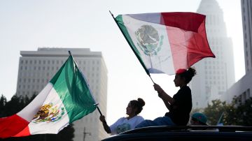 Demonstrators wave flags during a protest calling for immigration reform Sunday, Feb. 2, 2025, in Los Angeles. (AP Photo/Eric Thayer)