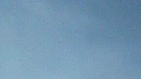 Col. Eric Swenson, center, of the U.S. Army Corps of Engineers, stands in front of a U.S. and California flag before a visit by California Gov. Gavin Newsom to an area affected by the Eaton Fire Tuesday, Feb. 11, 2025, in Altadena, Calif. (AP Photo/Damian Dovarganes)