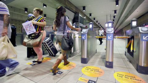 A passenger using the new TAP card as she passes through the subway at Union Station Wednesday June 19, 2013 in Los Angeles. From now on, there's no free ride on the Los Angeles subway. Subway turnstiles will be locked at Union Station entrances to the Metro Red and Purple lines. Riders must have a so-called TAP card pre-loaded with at least the $1.50 basic fare to unlock the turnstiles to gain access. (AP Photo/Nick Ut)