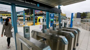 Commuters enter the Downtown Santa Monica light train station to mark the opening of the 6.6-mile extension of the new Metro Expo Line in Santa Monica, Calif., on Friday, May 20, 2016. For the first time since the 1950s, a Southern California light rail line will extend to the Pacific. The Los Angeles County Metropolitan Transportation Authority says the ride from downtown Los Angeles to Santa Monica will take 48 minutes. That may hardly sound speedy for a 15-mile trip, but the nearly constant congestion of Interstate 10, the usual car route for the trip, can often take just as long or longer. (AP Photo/Damian Dovarganes)