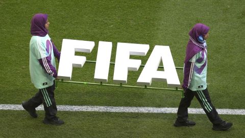 Stewards walk on the pitch before the start of World Cup group F soccer match between Morocco and Croatia at the Al Bayt Stadium in Al Khor, Qatar, Wednesday, Nov. 23, 2022. (AP Photo/Darko Vojinovic)