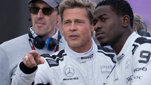 Brad Pitt, left, talks to actor Damson Idris on the grid before the British Formula One Grand Prix race at the Silverstone racetrack, Silverstone, England, Sunday, July 9, 2023. Production of Brad Pitt and Lewis Hamilton's F1 movie has begun at Silverstone. (AP Photo/Luca Bruno)