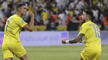 Al-Nassr's Cristiano Ronaldo, and Alex Telles, right, celebrate a goal against Al-Hilal during the Arab Club Champions Cup at King Fahd Stadium in Taif, Saudi Arabia, Saturday, Aug. 12, 2023. (AP Photo/Samah Zidan)