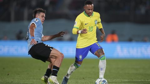 Brazil's Neymar, right, is challenged by Uruguay's Manuel Ugarte during a qualifying soccer match for the FIFA World Cup 2026 at Centenario stadium in Montevideo, Uruguay, Tuesday, Oct. 17, 2023. (AP Photo/Matilde Campodonico)