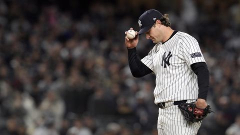 New York Yankees starting pitcher Gerrit Cole adjusts his cap while throwing against the Cleveland Guardians during the fourth inning in Game 2 of the baseball AL Championship Series Tuesday, Oct. 15, 2024, in New York. (AP Photo/Godofredo Vásquez)