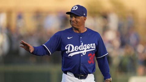 Los Angeles Dodgers manager Dave Roberts walks to the dugout before a spring training baseball game against the Los Angeles Angels, Friday, Feb. 28, 2025, in Phoenix. (AP Photo/Ashley Landis)