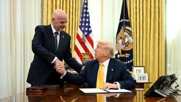 President Donald Trump, right, and FIFA President Gianni Infantino shake hands after Trump signed an executive order in the Oval Office of the White House in Washington, Friday, March 7, 2025. (Pool via AP)