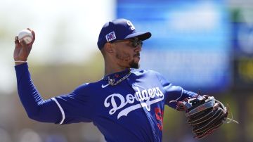 Los Angeles Dodgers shortstop Mookie Betts warms up prior to a spring training baseball game against the Athletics Sunday, March 9, 2025, in Phoenix. (AP Photo/Ross D. Franklin)