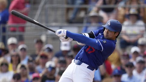 Los Angeles Dodgers designated hitter Shohei Ohtani, of Japan, follows through with his swing during the second inning of a spring training baseball game against the Cleveland Guardians, Tuesday, March 11, 2025, in Phoenix. (AP Photo/Ross D. Franklin)