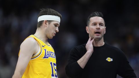 Los Angeles Lakers guard Austin Reaves, left, confers with head coach JJ Redick in the second half of an NBA basketball game against the Denver Nuggets, Friday, March 14, 2025, in Denver. (AP Photo/David Zalubowski)