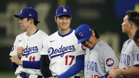 Los Angeles Dodgers' Roki Sasaki (11), Shohei Ohtani (17), Chicago Cubs' Shota Imanaga and Seiya Suzuki, right, prepare to pose for a group photo after their team's MLB Tokyo Series baseball game in Tokyo, Japan, Wednesday, March 19, 2025. (AP Photo/Hiro Komae)