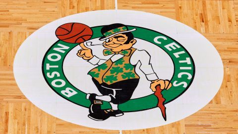 FILE - The Boston Celtics logo is seen at center court on the parquet floor before an NBA basketball game between the Boston Celtics and the Atlanta Hawks Sunday, Feb. 13, 2022, in Boston. (AP Photo/Winslow Townson, File)