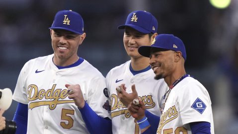 Los Angeles Dodgers' Freddie Freeman, left, Shohei Ohtani, center, and Mookie Betts pose with their rings during a World Series Champion ring ceremony prior to a baseball game against the Detroit Tigers, Friday, March 28, 2025, in Los Angeles. (AP Photo/Mark J. Terrill)