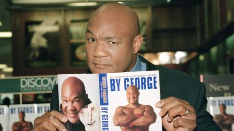 Former heavyweight boxing champion George Foreman poses with his autobiography, prior to a book signing in New York, on May 15, 1995. (AP Photo/Kathy Willens)