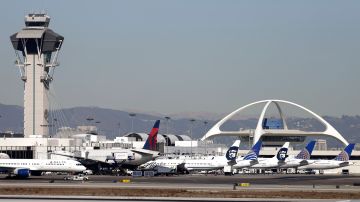 Airplanes sit on the tarmac at Los Angeles International Airport Friday, Nov. 1, 2013. Thousands of fliers were delayed Friday after a shooting in Terminal 3 closed parts of the airport for hours, prompting authorities to evacuate a terminal and stop flights headed for the city from taking off from other airports. Los Angeles police said a suspected gunman has been taken into custody. (AP Photo/Gregory Bull)