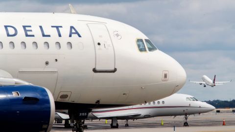 FILE - In this Aug. 8, 2017, file photo, a Delta Air Lines jet waits on the tarmac at LaGuardia Airport in New York. A false offer circulating on Facebook shows what appears to be a promotion from Delta claiming the company is giving away free tickets to celebrate its 93rd birthday. Delta says the promotion is a fake and the airline is not celebrating its 93rd birthday this year. (AP Photo/Mary Altaffer, File)