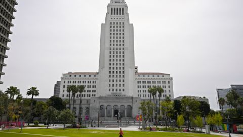 A few people use Grand Park at the foot of Los Angeles City Hall, Tuesday, March 31, 2020, in Los Angeles. The new coronavirus causes mild or moderate symptoms for most people, but for some, especially older adults and people with existing health problems, it can cause more severe illness or death. (AP Photo/Mark J. Terrill)