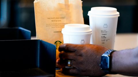 A customer picks up their drink at a Starbucks retail location, Wednesday, June 28, 2023, in Seattle. (AP Photo/Lindsey Wasson)