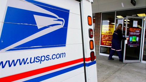 U.S. Letter Carrier Kelly Wendling picks up and delivers mail to businesses Tuesday, Dec. 6, 2011 in Springfield, Il. For some mail-dependent businesses, quick and cheap first-class mail service from the U.S. Postal Service is still the best way to reach prospective customers and subscribers. (AP Photo/Seth Perlman)