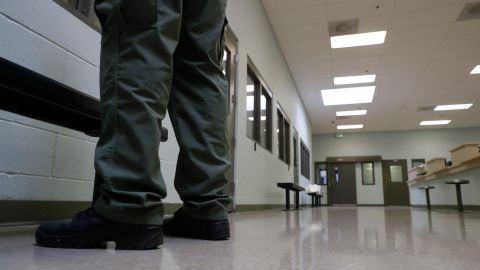 In this Wednesday, Aug. 28, 2019, photo shows a guard standing in the intake area at the Adelanto ICE Processing Center in Adelanto, Calif. The facility is a privately operated immigration detention center run by the GEO Group, which can house up to about 1900 total immigrant detainees, both male and female. (AP Photo/Chris Carlson)