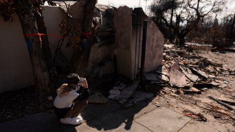 Eaton Fire evacuee Ceiba Phillips, 11, is overwhelmed with emotion as he visits his best friend's home, which was devastated by the fire, across the street from his own in Altadena, Calif., Saturday, Feb. 8, 2025. (AP Photo/Jae C. Hong)