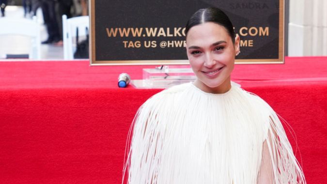 Gal Gadot poses with her new star at a ceremony honoring her on the Hollywood Walk of Fame on Tuesday, March 18, 2025, in Los Angeles. (Photo by Jordan Strauss/Invision/AP)