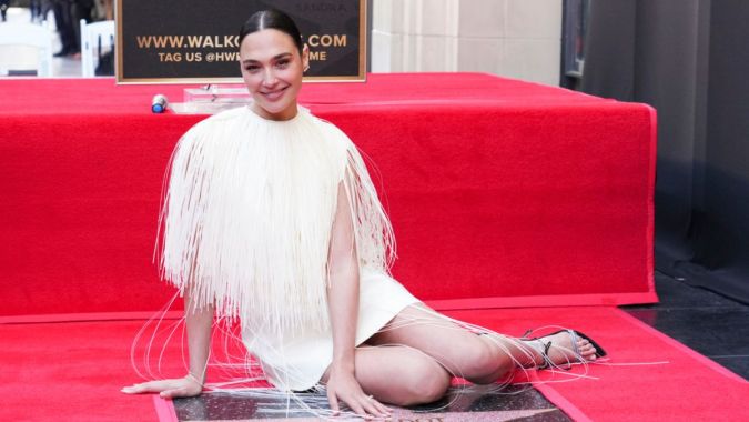 Gal Gadot poses with her new star at a ceremony honoring her on the Hollywood Walk of Fame on Tuesday, March 18, 2025, in Los Angeles. (Photo by Jordan Strauss/Invision/AP)