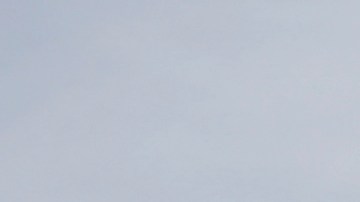 FILE - In this Oct. 10, 2019, file photo, a helicopter drops water near power lines and electrical towers while working at a fire on San Bruno Mountain near Brisbane, Calif. Pacific Gas & Electric plans to bury 10,000 miles of its power lines in an effort to prevent its fraying grid from sparking wildfires when electrical equipment collides with millions of trees and other vegetation sprawling across its drought-stricken service. (AP Photo/Jeff Chiu, File)