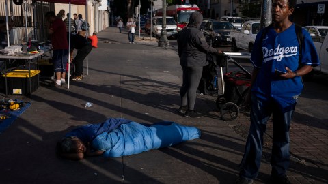 A homeless person sleeps on a sidewalk in Los Angeles, Friday, Sept. 15, 2023. (AP Photo/Jae C. Hong)