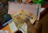 Duane Bouligny holds up Powerball tickets he purchased at Moza Easy Shop in San Francisco, Wednesday, Jan. 13, 2016. The Powerball jackpot for Wednesday night's drawing is at least $1.5 billion, the largest lottery jackpot in the world. (AP Photo/Jeff Chiu)