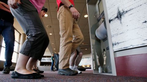 Visitors stomp their feet at a new digital seismograph exhibit at the Johnston Ridge Observatory at Mount St. Helens National Volcanic Monument, Friday, May 14, 2010, near Toutle, Wash. Tuesday will mark the 30th anniversary of the big eruption of May 18, 1980, that killed 57 people, knocked down a forest, filled local rivers with mudflows and rained ash far downwind. (AP Photo/Elaine Thompson)