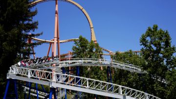 FILE--In this June 27, 2016, file photo, riders enjoy The New Revolution, a virtual reality roller coaster at Six Flags Magic Mountain in Valencia, Calif. Southern California's Six Flags Magic Mountain theme park will be open every day of the year beginning in 2018. (AP Photo/Christine Armario, file)