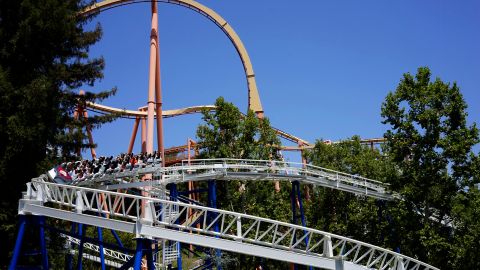 FILE--In this June 27, 2016, file photo, riders enjoy The New Revolution, a virtual reality roller coaster at Six Flags Magic Mountain in Valencia, Calif. Southern California's Six Flags Magic Mountain theme park will be open every day of the year beginning in 2018. (AP Photo/Christine Armario, file)