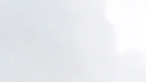 A morning commuter shields herself from the rain as she walks past the Walt Disney Concert Hall in downtown Los Angeles, Friday, May 6, 2016. Forecasters say a cold slow-moving storm packing an unusually high volume of moisture will douse the area and may trigger thunderstorms. (AP Photo/Nick Ut)