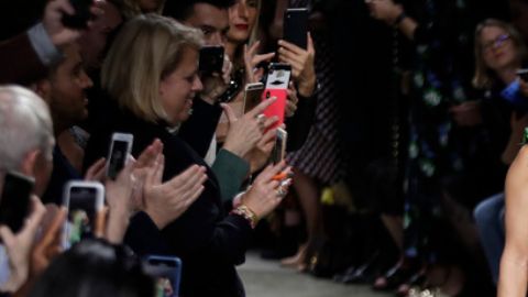 Actress Jennifer Lopez, left, and designer Donatella Versace accept applause at the conclusion of the Versace Spring-Summer 2020 collection, unveiled during the fashion week, in Milan, Italy, Friday, Sept. 20, 2019. (AP Photo/Luca Bruno, File)