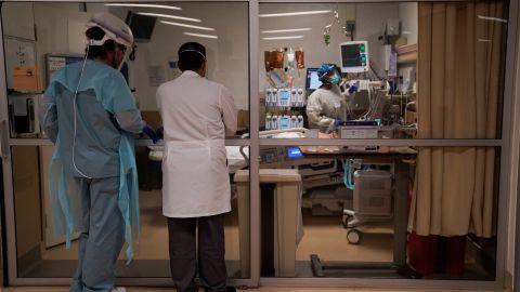 Respiratory therapist Paul Knaack, left, and Dr. Mher Onanyan check on a COVID-19 patient in an intensive care unit at Providence Holy Cross Medical Center in the Mission Hills section of Los Angeles, Tuesday, Dec. 22, 2020. (AP Photo/Jae C. Hong)