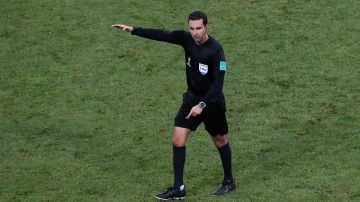 Referee Cesar Ramos from Mexico directs the players during the round of 16 match between Uruguay and Portugal at the 2018 soccer World Cup at the Fisht Stadium in Sochi, Russia, Saturday, June 30, 2018. (AP Photo/Darko Vojinovic)