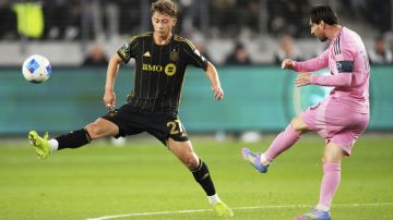 Inter Miami forward Lionel Messi, right, kicks past Los Angeles FC forward Nathan Ordaz during the first half of an MLS soccer match, Wednesday, April 2, 2025, in Los Angeles. (AP Photo/Mark J. Terrill)
