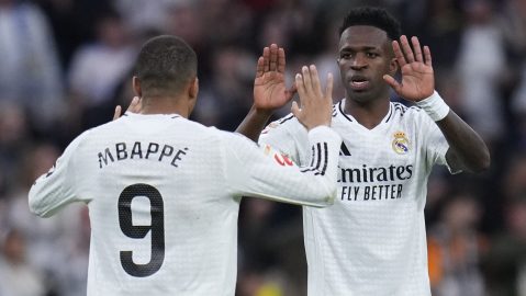 Real Madrid's Vinicius Junior, right, celebrates with Kylian Mbappe after scoring his side's first goal against Valencia during a Spanish La Liga soccer match between Real Madrid and Valencia at the Santiago Bernabeu stadium in Madrid, Spain, Saturday, April 5, 2025. (AP Photo/Manu Fernandez)