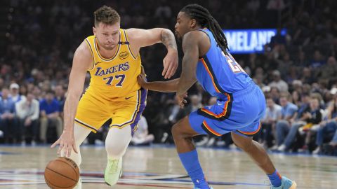 Los Angeles Lakers guard Luka Doncic, left, drives past Oklahoma City Thunder guard Cason Wallace, right, during the first half of an NBA basketball game, Tuesday, April 8, 2025, in Oklahoma City. (AP Photo/Kyle Phillips)