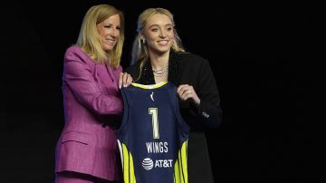 Paige Bueckers posa con su nueva camiseta junto a la comisionada de la WNBA.