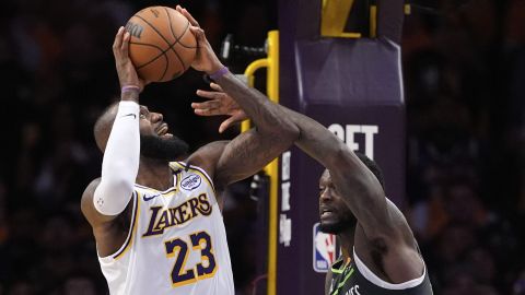 Los Angeles Lakers forward LeBron James, left, tires to shoot as Minnesota Timberwolves forward Julius Randle defends during the second half in Game 1 of an NBA first-round playoff series Saturday, April 19, 2025, in Los Angeles. (AP Photo/Mark J. Terrill)