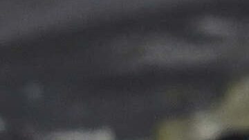 Candles surround a portrait of the late Pope Francis, wrapped in a banner of the San Lorenzo soccer club, of which he was a fan, at the Cathedral in Buenos Aires, Argentina, Monday, April 21, 2025. (AP Photo/Gustavo Garello)