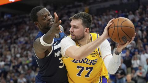 Los Angeles Lakers guard Luka Doncic (77) looks to pass as Minnesota Timberwolves forward Julius Randle (30) defends during the second half of Game 3 of an NBA basketball first-round playoff series, Friday, April 25, 2025, in Minneapolis. (AP Photo/Abbie Parr)