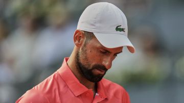 Novak Djokovic of Serbia reacts during his match against Matteo Arnaldi of Italy during the Madrid Open tennis tournament in Madrid, Spain, Saturday, April 26, 2025. (AP Photo/Manu Fernandez)