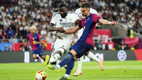 Real Madrid's Antonio Rudiger, left, challenges for the ball with Barcelona's Ferran Torres during the Spanish Copa del Rey final soccer match between Barcelona and Real Madrid at Estadio de La Cartuja stadium in Seville, Spain, Sunday, April 27, 2025. (AP Photo/Jose Breton)